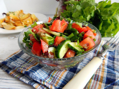 Salad with cucumbers and tomatoes with butter