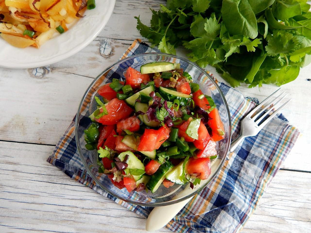 Salad with cucumbers and tomatoes with butter