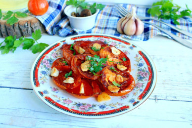 Fried tomatoes in a pan with garlic