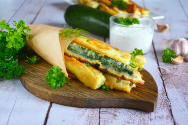 Fried zucchini in a pan with garlic