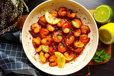 Fried shrimp with garlic in soy sauce in a frying pan