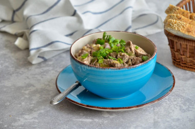 Chicken liver in sour cream with onions, fried in a pan