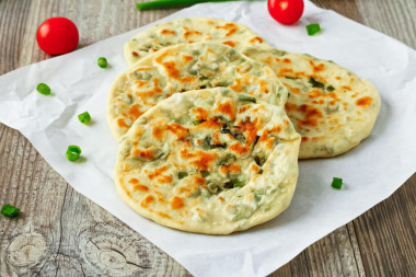 Tortillas with green onions in a pan