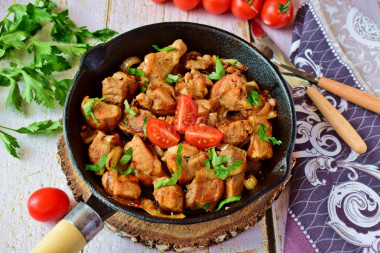 Pork fried in pieces in a pan with onions