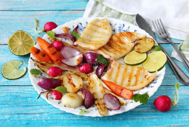 Fried squid in a pan with onions