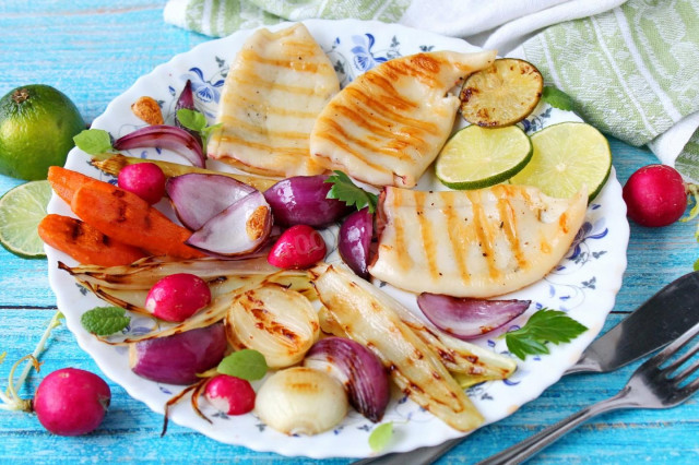 Fried squid in a pan with onions