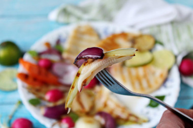 Fried squid in a pan with onions