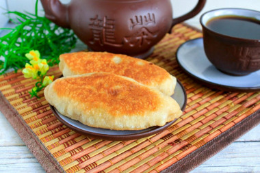 Fried cabbage pies in a frying pan