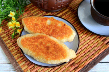 Fried cabbage pies in a frying pan