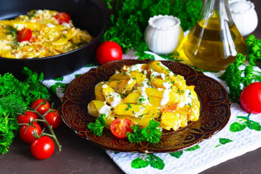 Fried potatoes in sour cream in a frying pan