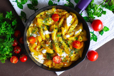 Fried potatoes in sour cream in a frying pan