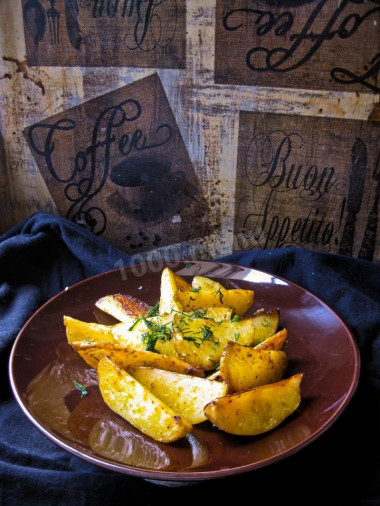 Fried potatoes with garlic in a frying pan rustic