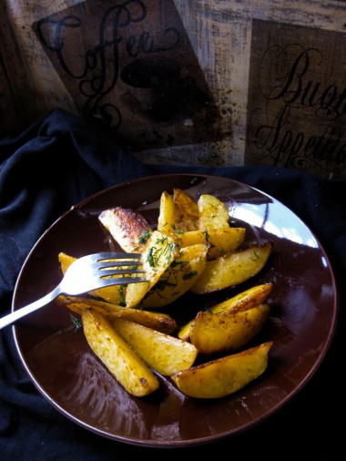 Fried potatoes with garlic in a frying pan rustic