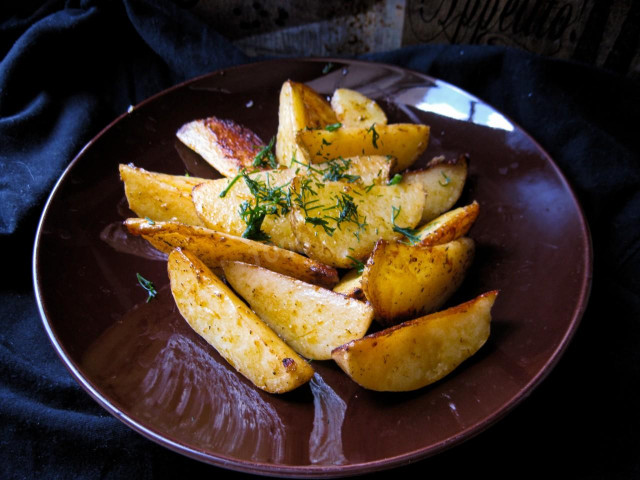 Fried potatoes with garlic in a frying pan rustic