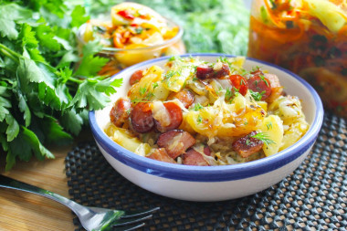 Fried potatoes with cabbage in a frying pan