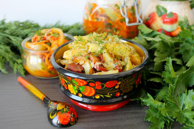 Fried potatoes with cabbage in a frying pan