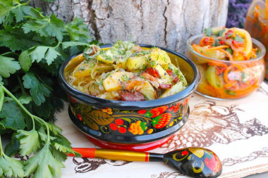 Fried potatoes with cabbage in a frying pan