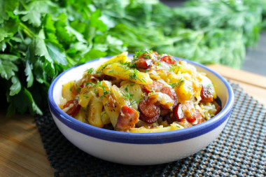 Fried potatoes with cabbage in a frying pan