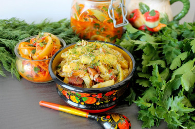 Fried potatoes with cabbage in a frying pan