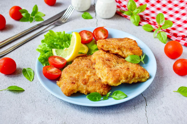 Pollock fish in breadcrumbs fried in a frying pan