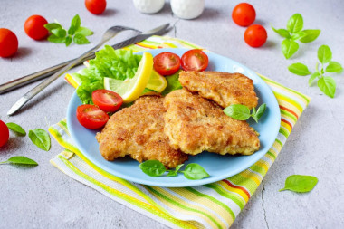 Pollock fish in breadcrumbs fried in a frying pan