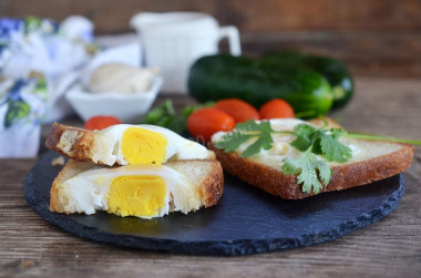 Fried egg in a bun on frying pan