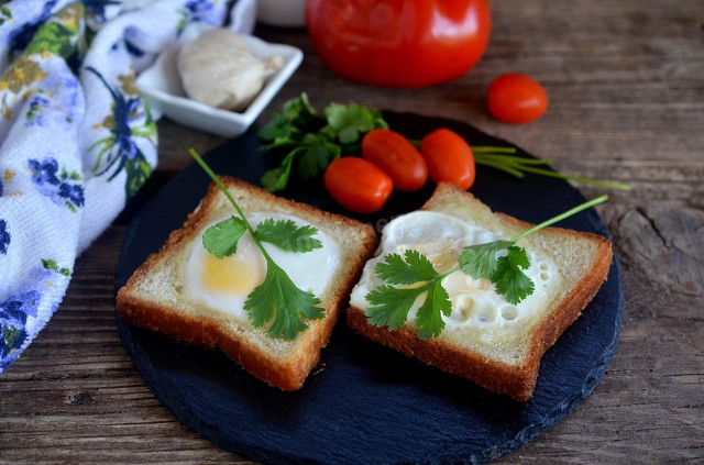 Fried egg in a bun on frying pan