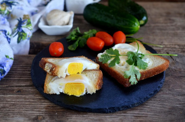 Fried egg in a bun on frying pan