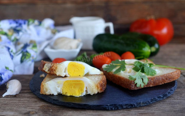 Fried egg in a bun on frying pan