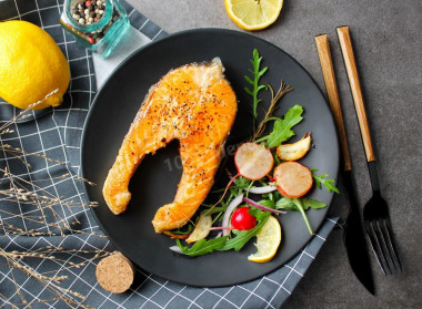 Juicy pink salmon fried in a pan