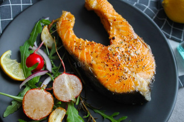 Juicy pink salmon fried in a pan