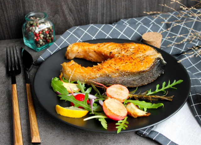 Juicy pink salmon fried in a pan