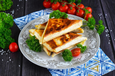 Pita bread with cheese fried in a pan