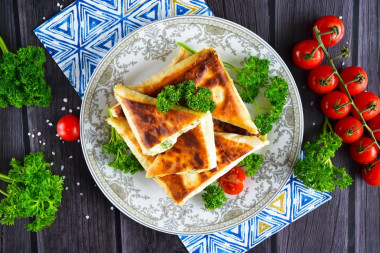 Pita bread with cheese fried in a pan