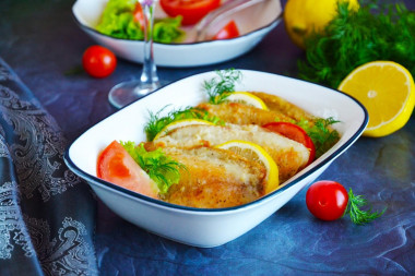 Tilapia fillet in flour in a frying pan