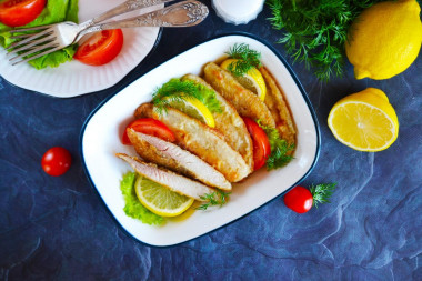 Tilapia fillet in flour in a frying pan