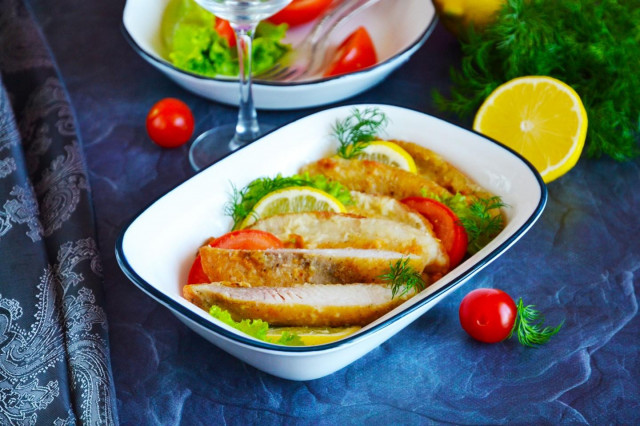 Tilapia fillet in flour in a frying pan