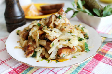 Fried cabbage with meat in a frying pan