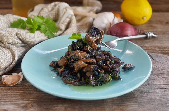 Fried mushrooms with garlic in a frying pan