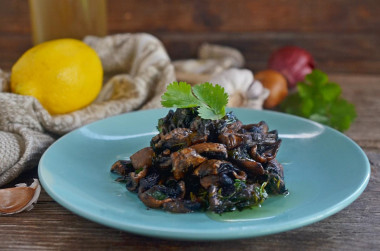 Fried mushrooms with garlic in a frying pan