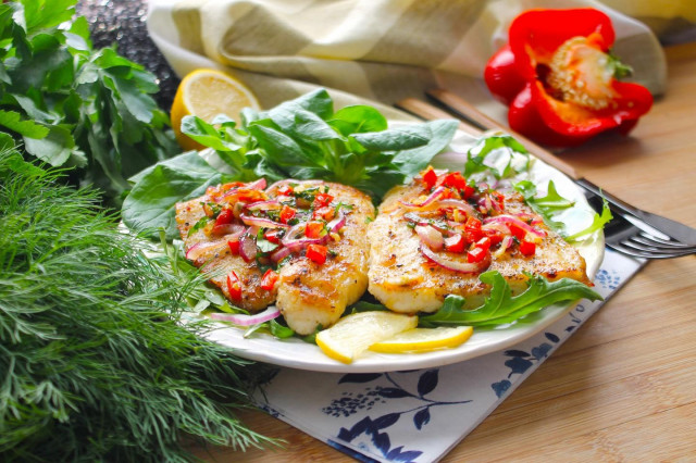 Pangasius on a grill pan with fried vegetables