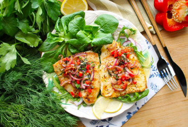 Pangasius on a grill pan with fried vegetables