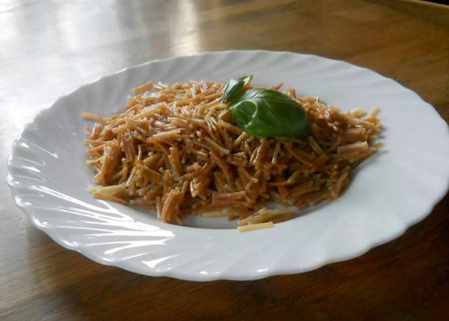 Fried noodles in oil in a frying pan