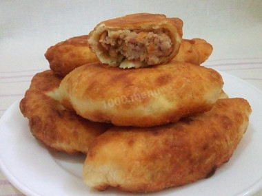 Bean pies fried from yeast dough in a frying pan