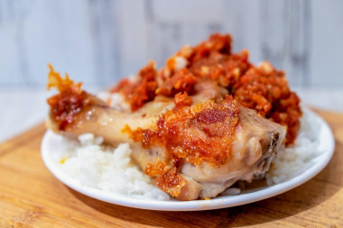 Fried chicken legs frying pan with vegetable sauce