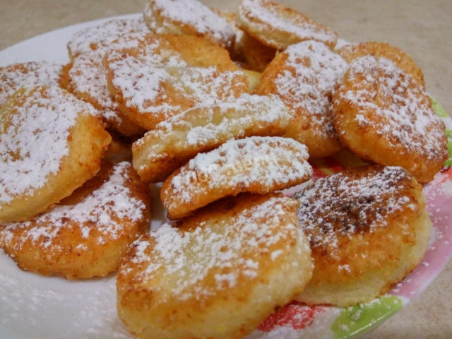 Fried cottage cheese pucks in a frying pan