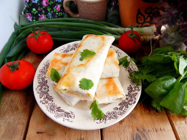 Pita bread in a frying pan with cheese