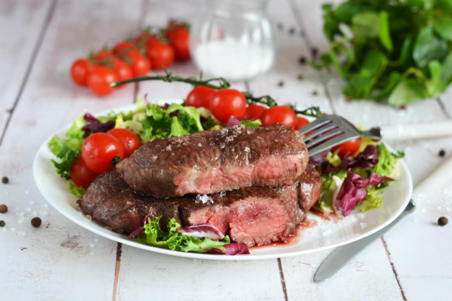 Rib eye steak in a frying pan