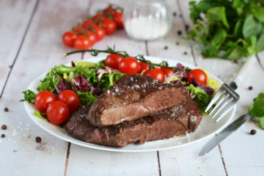 Rib eye steak in a frying pan