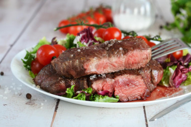 Rib eye steak in a frying pan